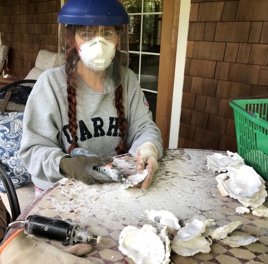 Kit Oz prepares oyster shells for painting.
