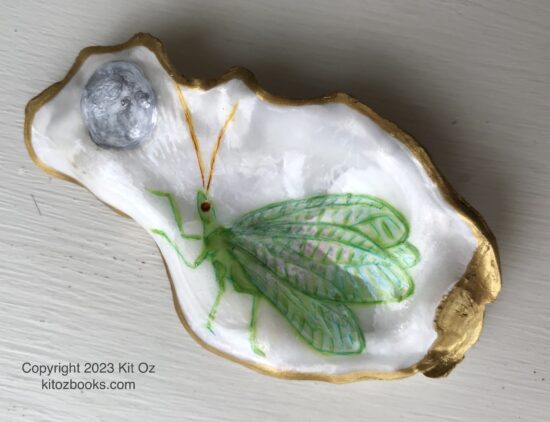 a delicate, pale green winged bug raises a tiny front leg in a gesture toward a silvery moon, all painted inside a small oyster shell