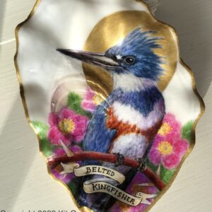 blue and white kingfisher with a gold halo, backed by pink wild roses, painted inside an oyster shell