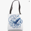 white tote bag with blue kraken squid on it. black handles