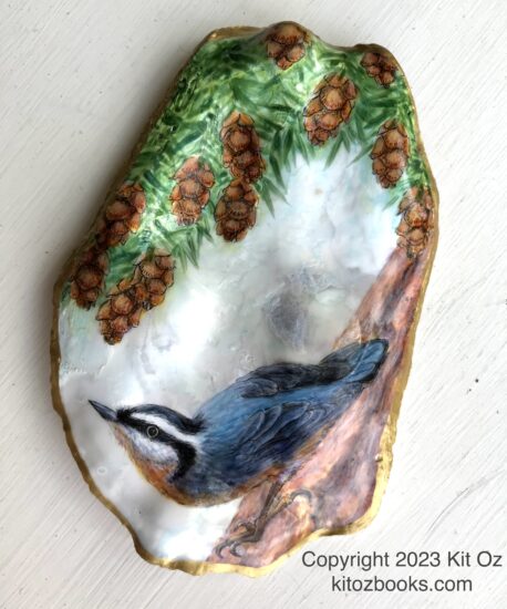 A large flat oyster shell. Inside it is painted a blue-grey nuthatch and the green needles and small brown pinecones of a hemlock.