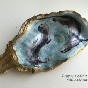 An oyster shell with gold trim. Inside it is painted a scene of two river otters swimming underwater. Blue-green background.